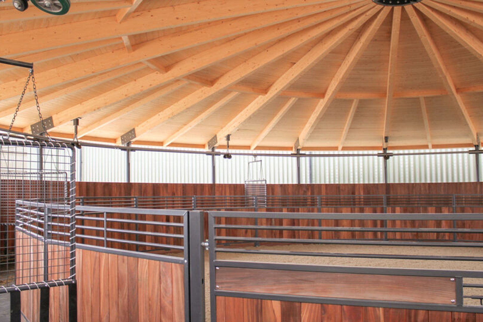 Interior view of a horse walker with roof made entirely of wood