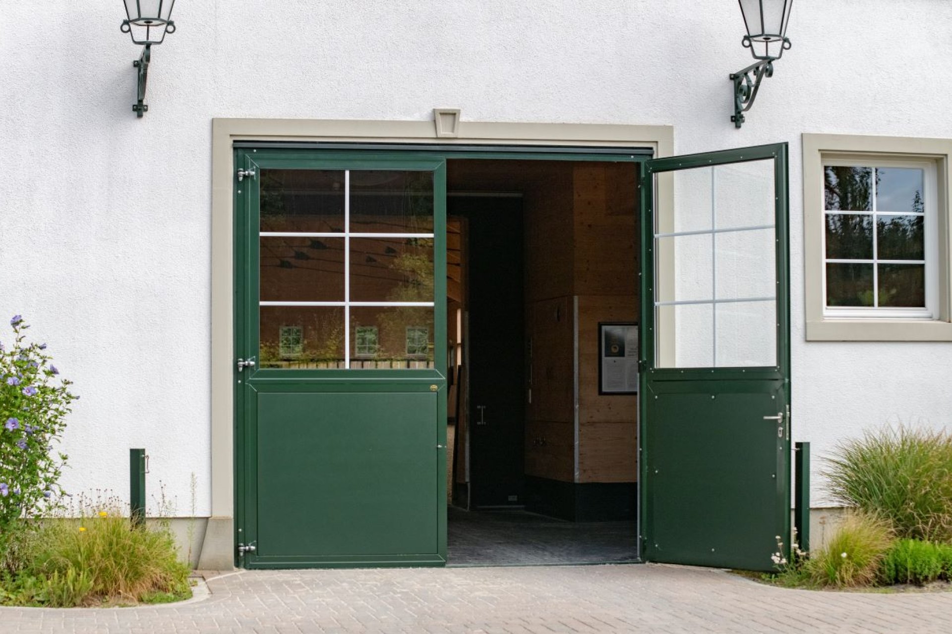 Porte d’écurie verte ouverte au Hofgut Albführen, équipement équestre de haute qualité avec fenêtre et design traditionnel.
